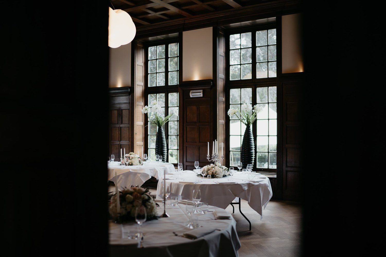 Michelle Jethro-005 - wedding reception tables decorated with flowers and candles in elegant wooden room.jpg