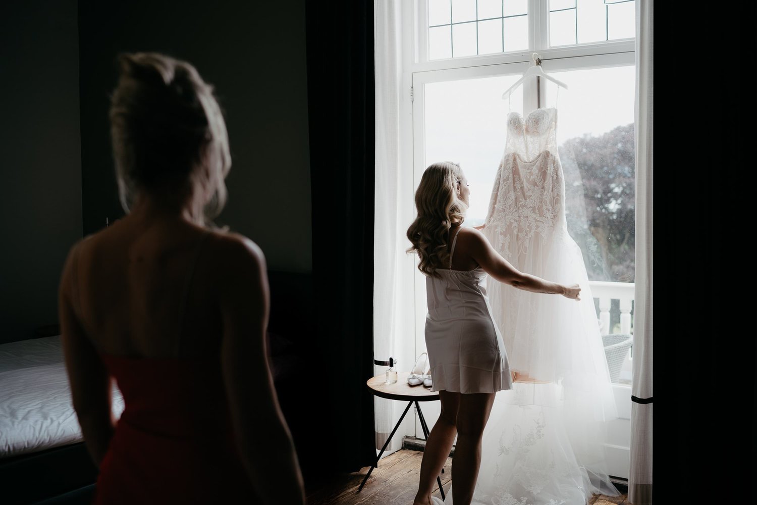 Michelle Jethro-047 - bride showing wedding dress to bridesmaid before ceremony.jpg