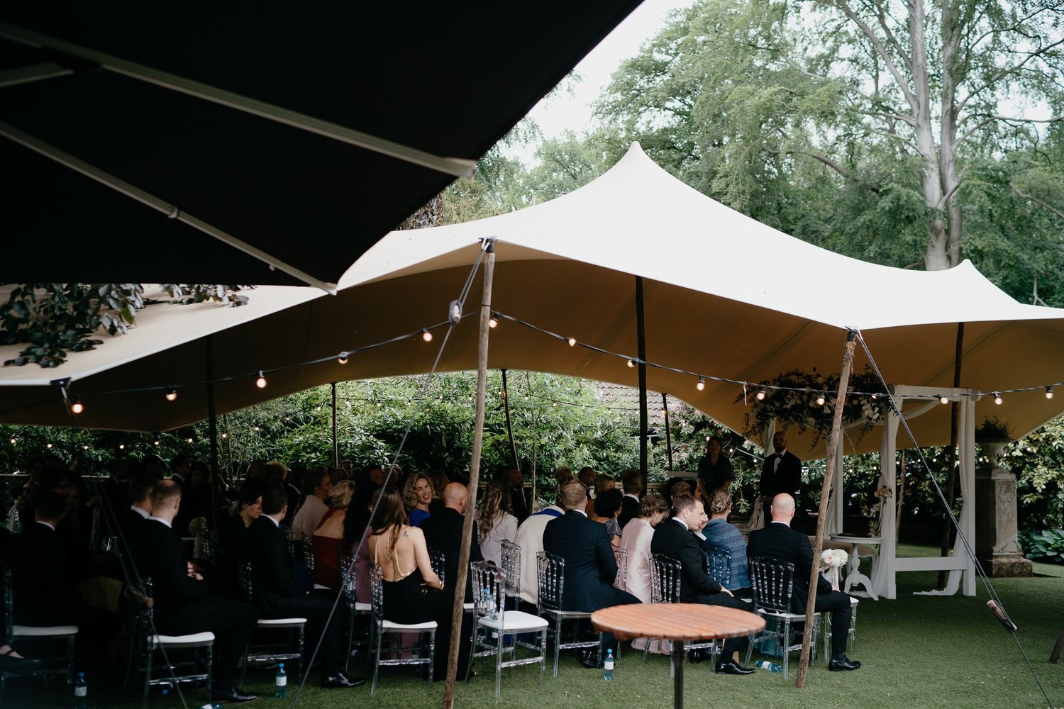 Michelle Jethro-067 - guests sitting under stretch tent during wedding ceremony.jpg