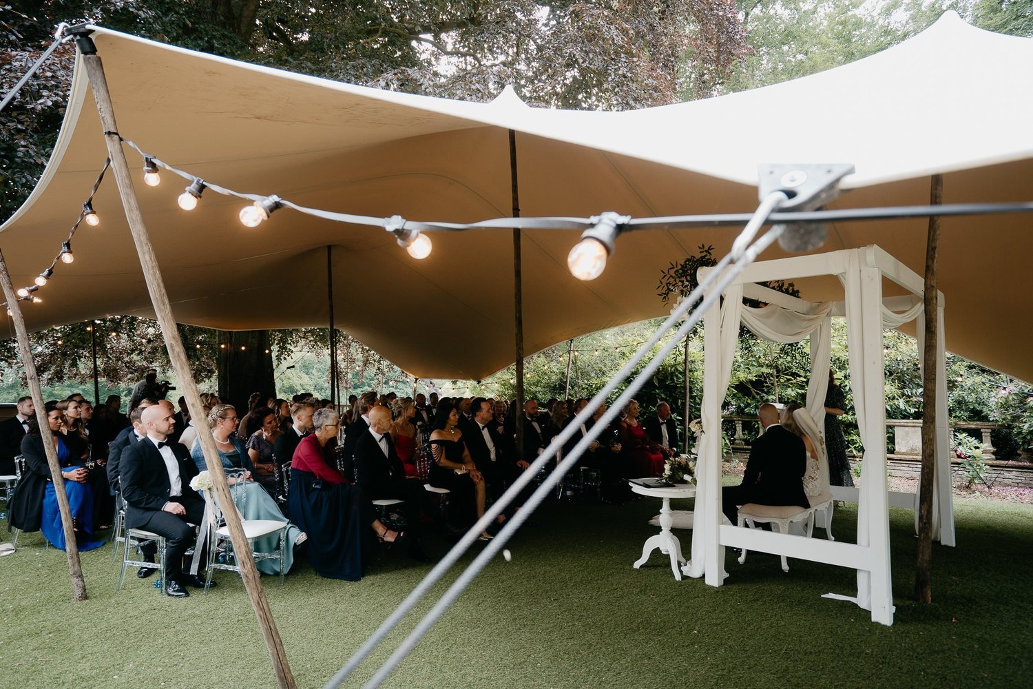 Michelle Jethro-085 - guests sitting under stretch tent during outdoor wedding ceremony.jpg