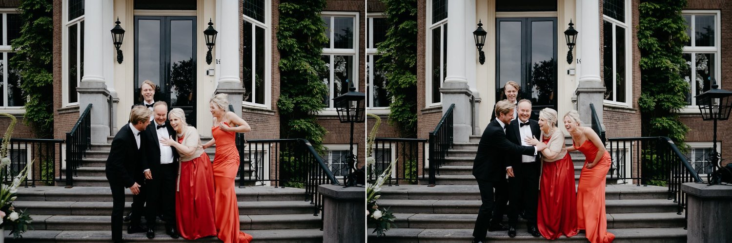 Michelle Jethro-250copy - wedding guests laughing together on steps of building in amsterdam.jpg