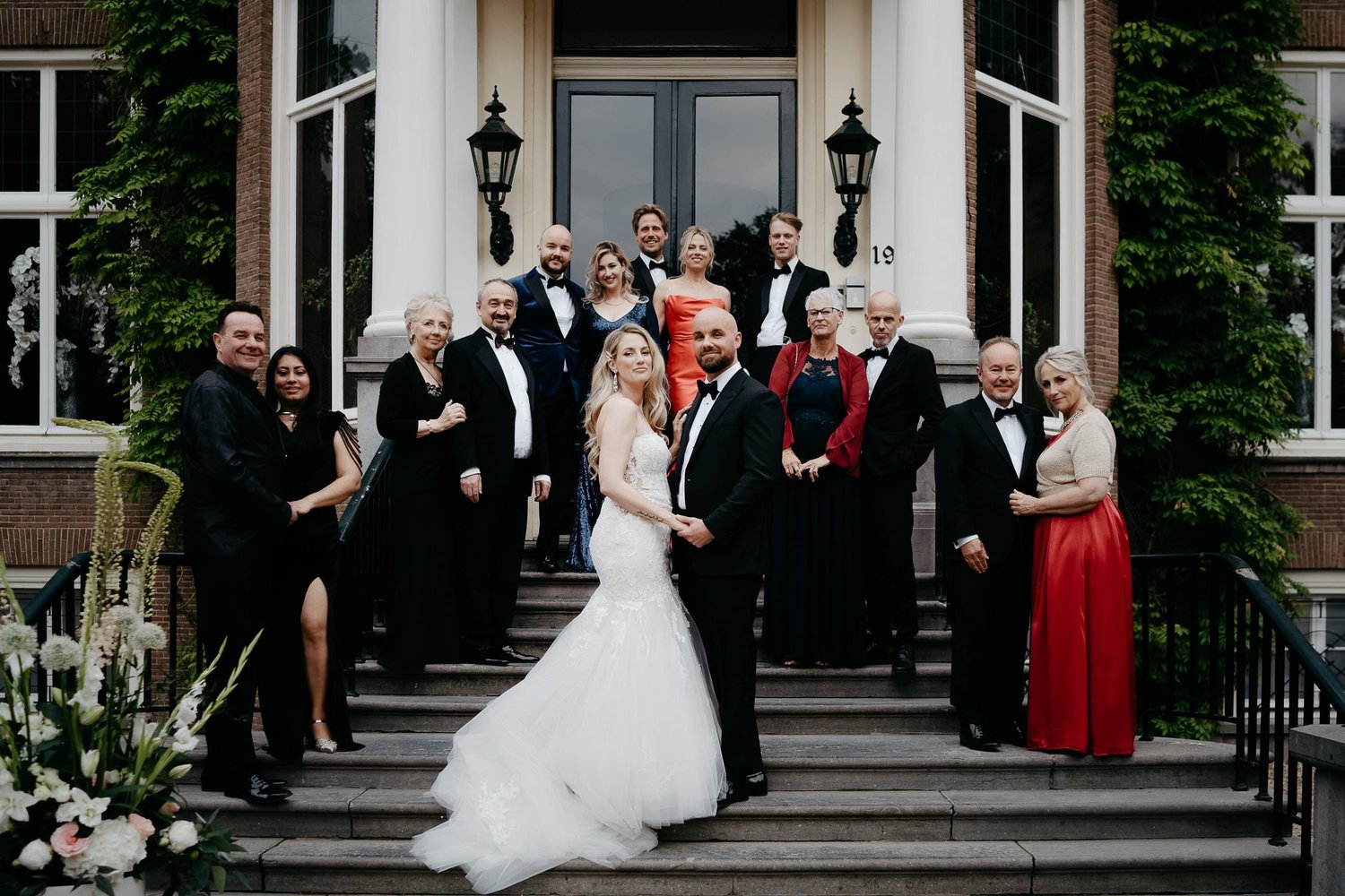 Michelle Jethro-277 - elegant wedding party posing on steps of amsterdam building.jpg
