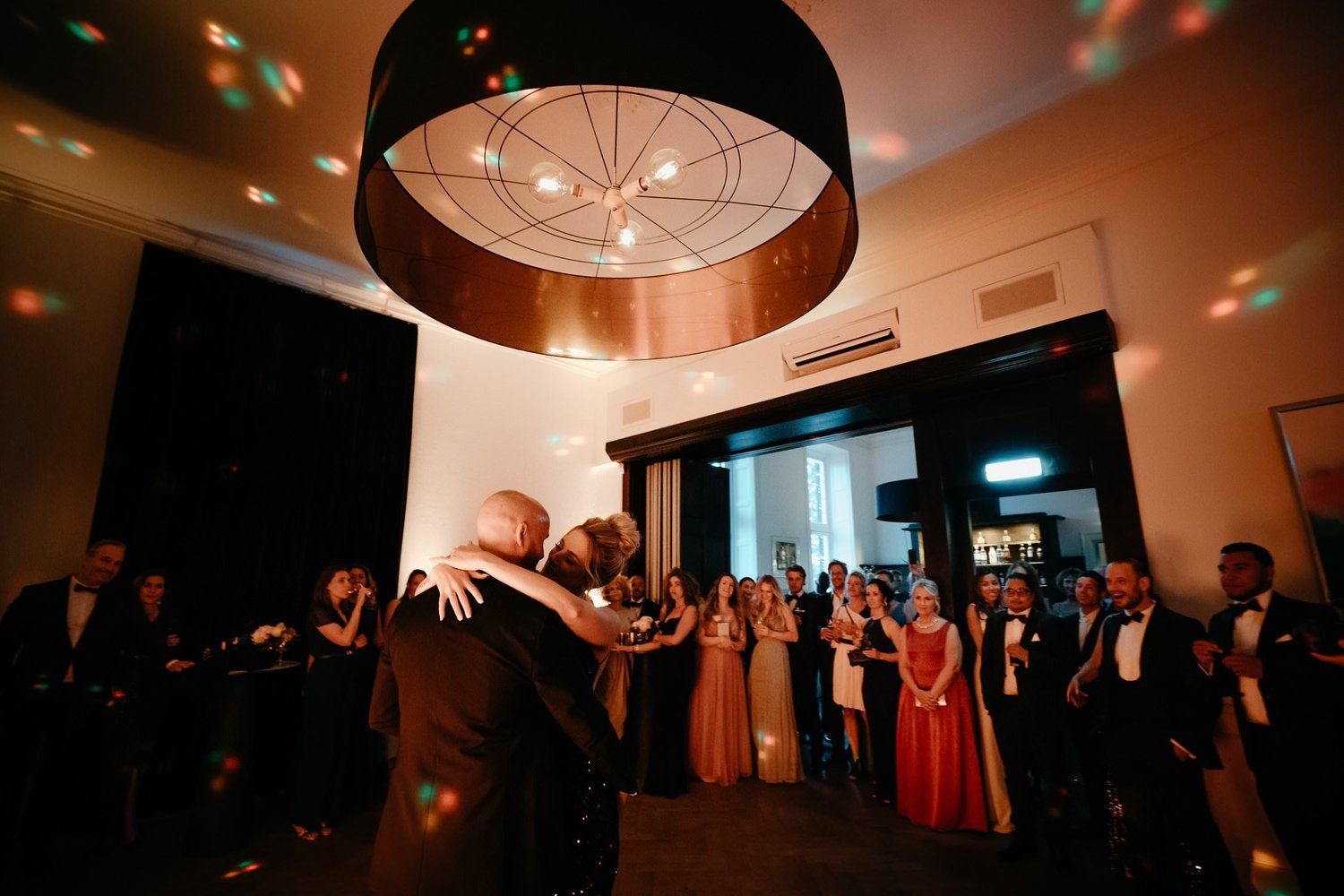 Michelle Jethro-297 - bride and groom embracing on dance floor, guests watching, amsterdam wedding reception.jpg