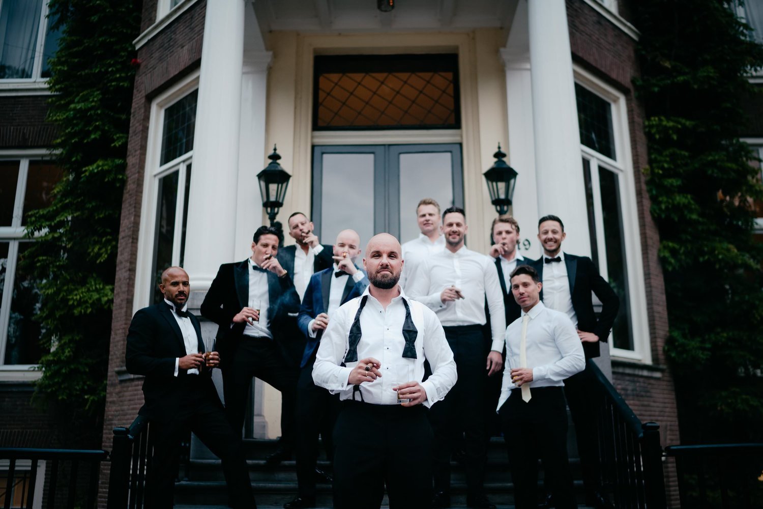 Michelle Jethro-306 - groomsmen smoking cigars and posing for photographer in amsterdam.jpg