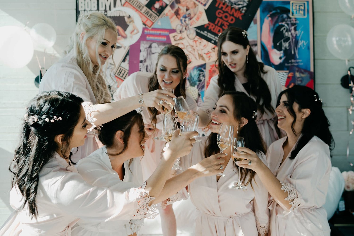 Kareline_Amir_044 - Bridesmaids wearing bathrobes toasting with champagne at pre-wedding party.jpg