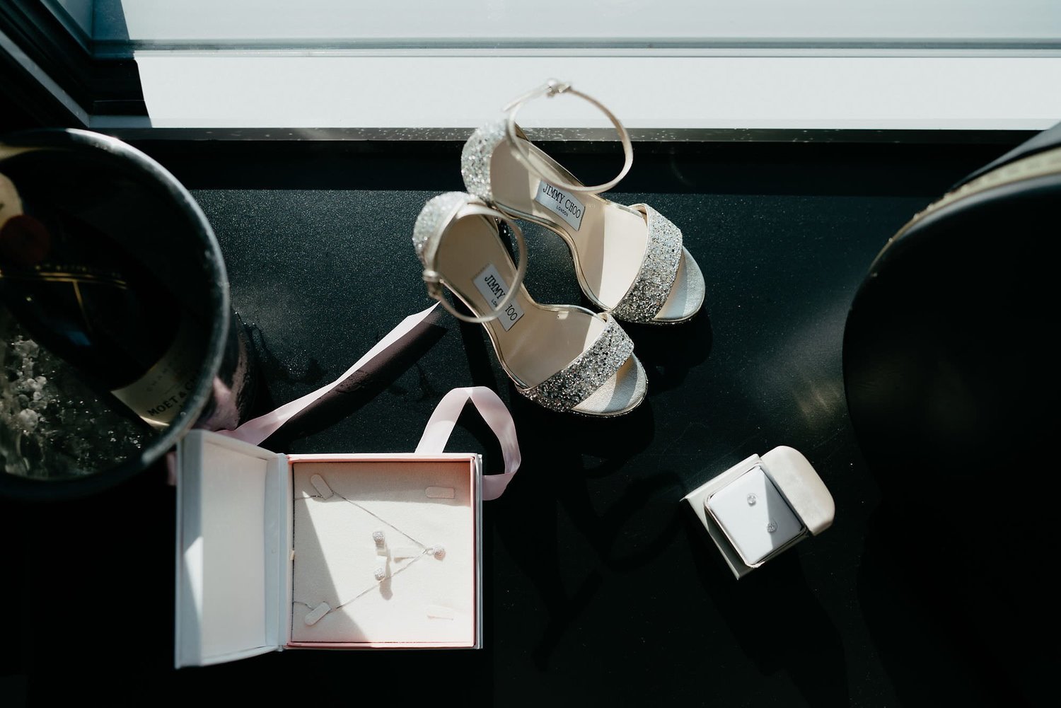 Kareline_Amir_026 - Elegant bridal shoes, jewelry, and champagne celebrating wedding day.jpg
