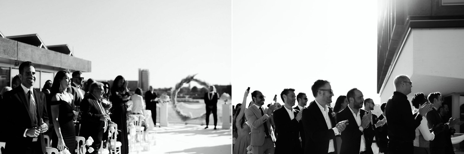 Kareline_Amir_087_2copy - Guests clapping and taking pictures at rooftop wedding ceremony in amsterdam.jpg