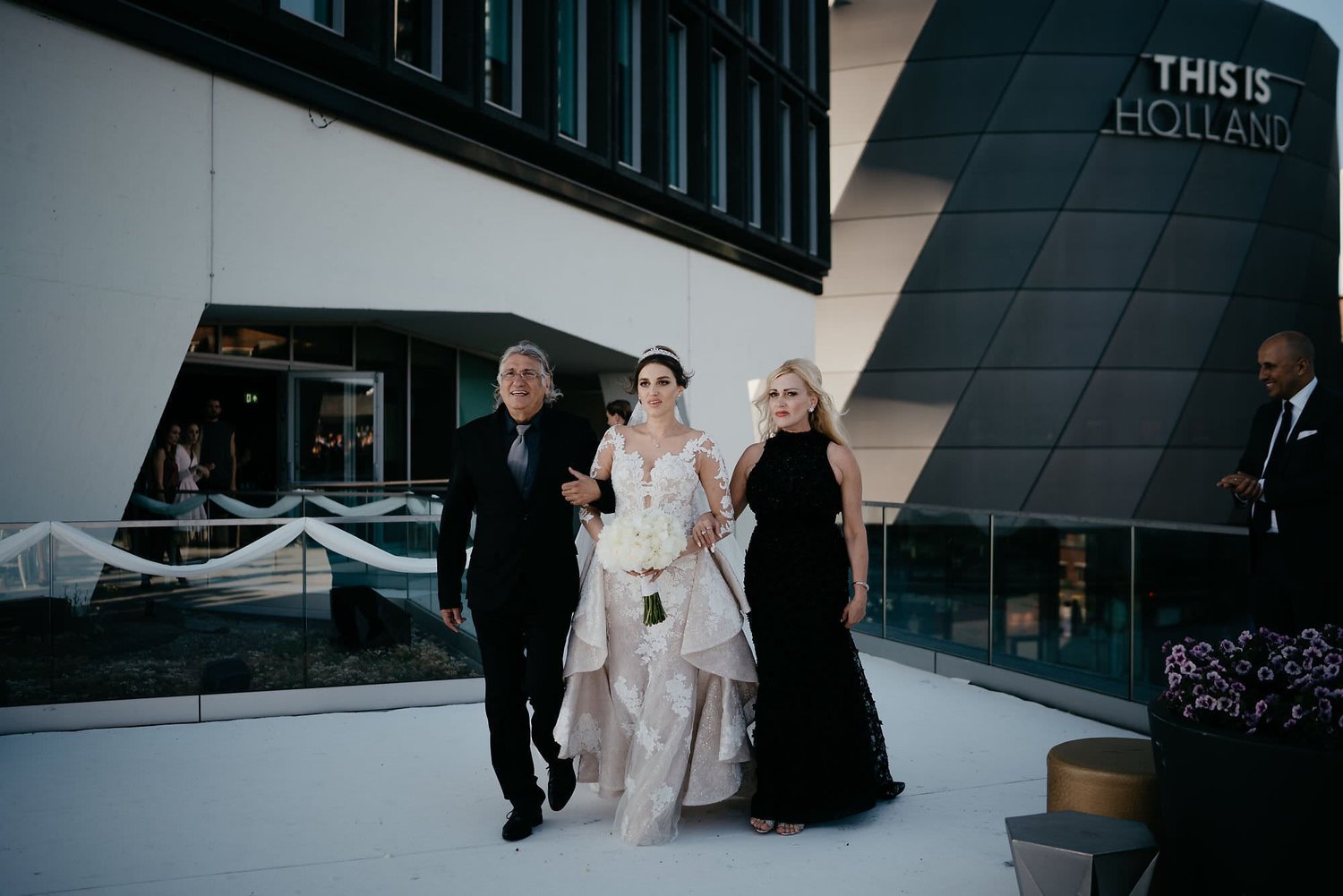 Kareline_Amir_088 - Bride walking with parents at a'dam tower wedding in amsterdam.jpg