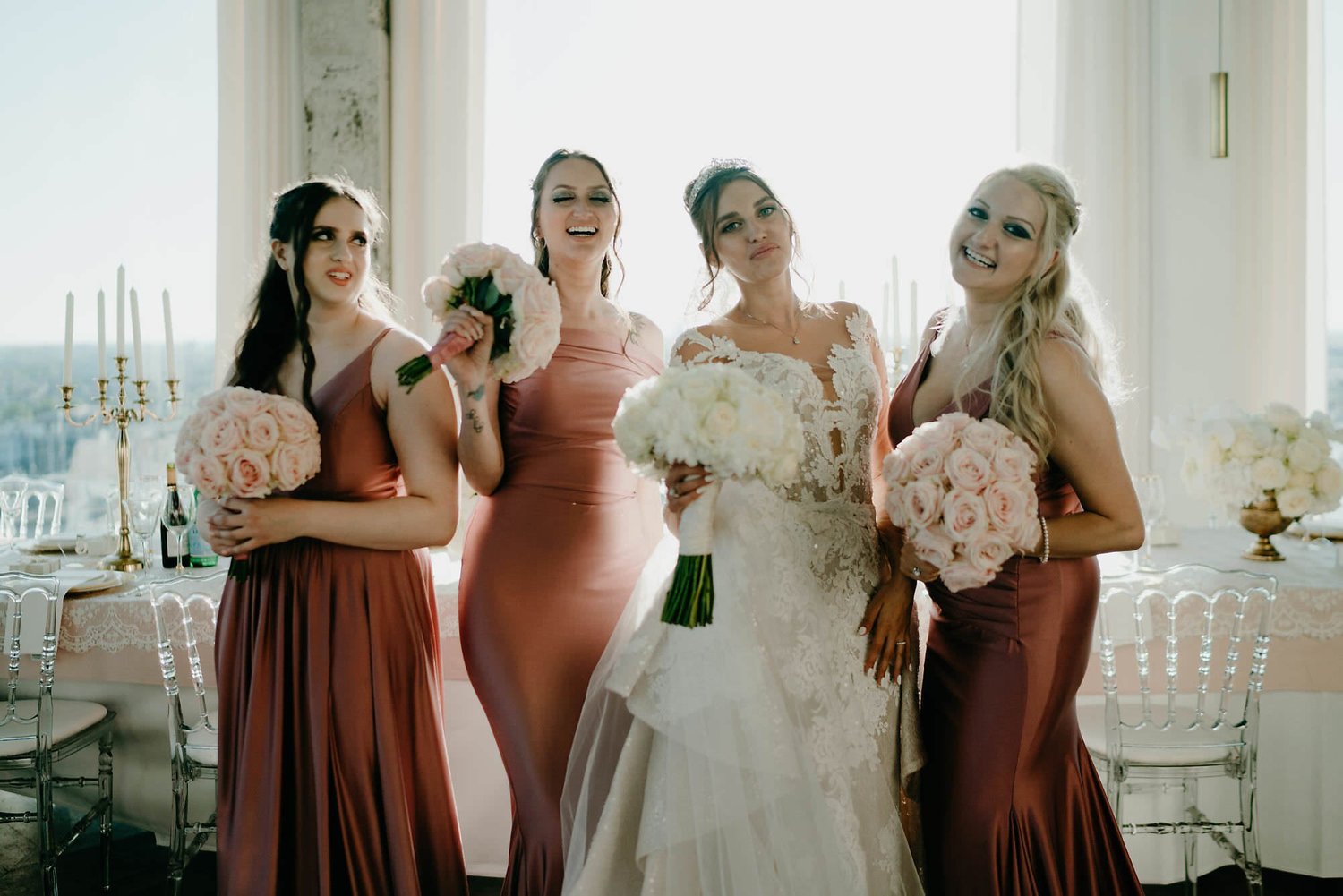 Kareline_Amir_208 - Bride posing with bridesmaids holding bouquets at a'dam tower in amsterdam.jpg