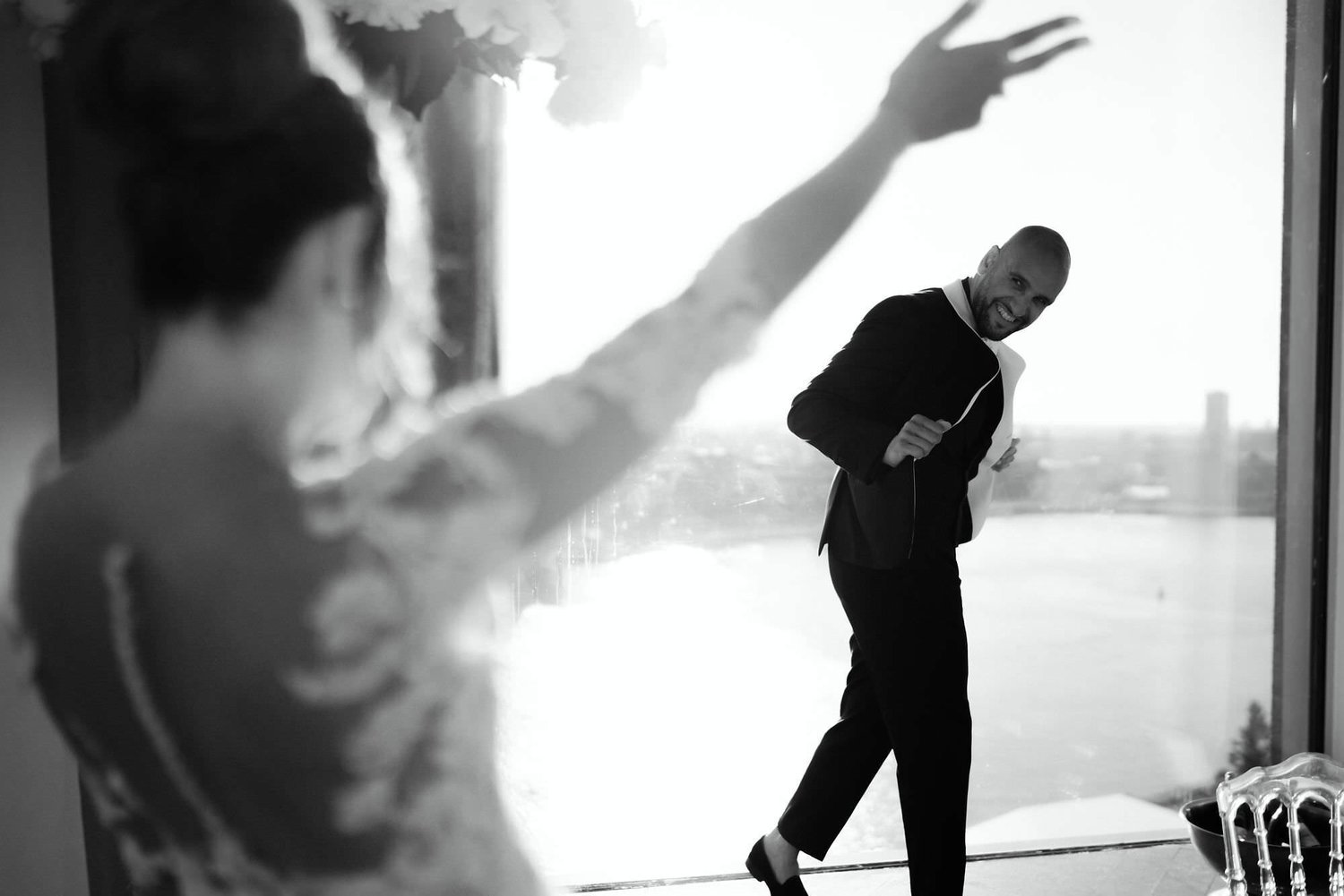 Kareline_Amir_301_2 - Groom making funny faces at his bride during photoshoot at a'dam tower in amsterdam.jpg