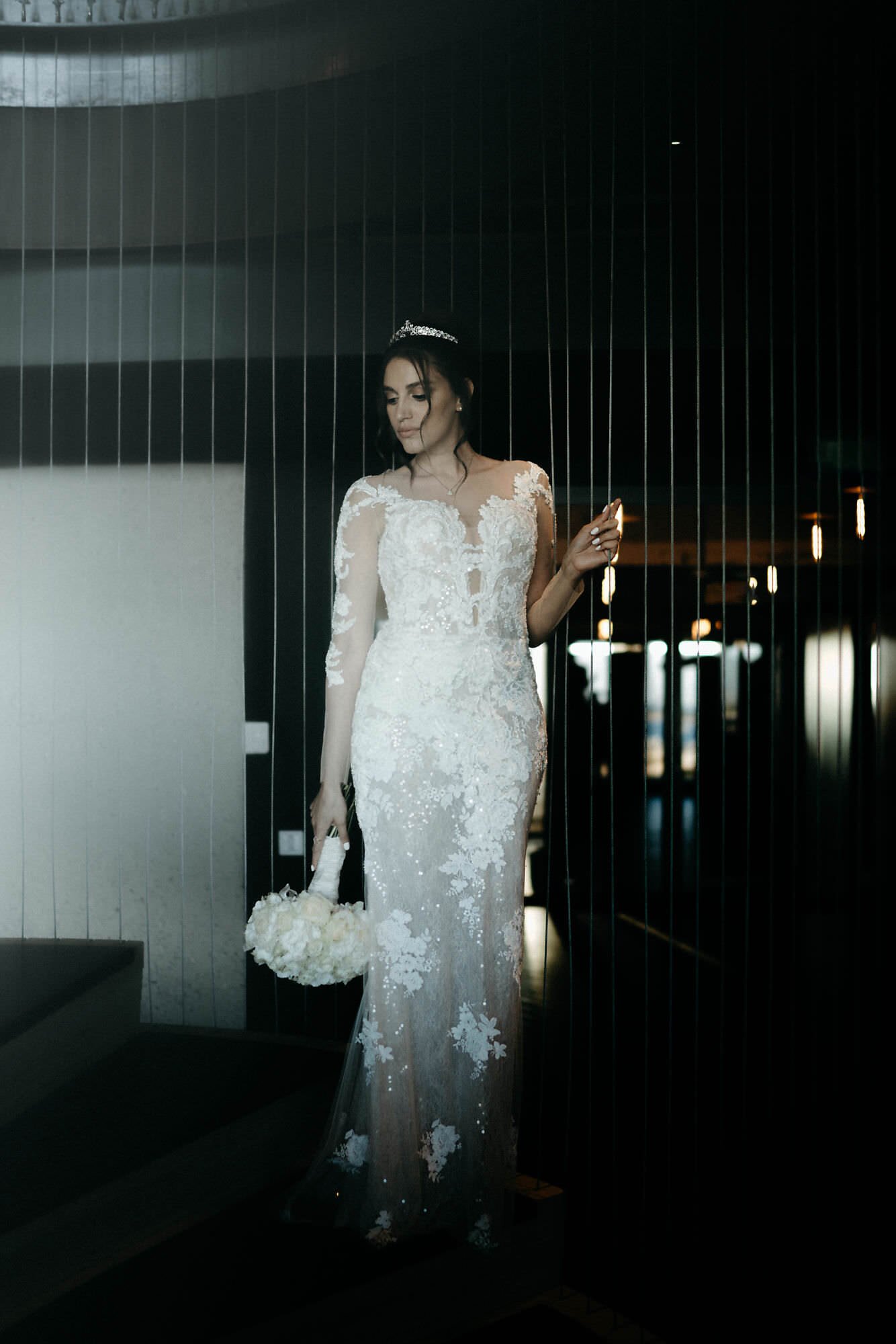 Kareline_Amir_528 - Bride holding bouquet posing at a'dam tower during wedding photoshoot.jpg