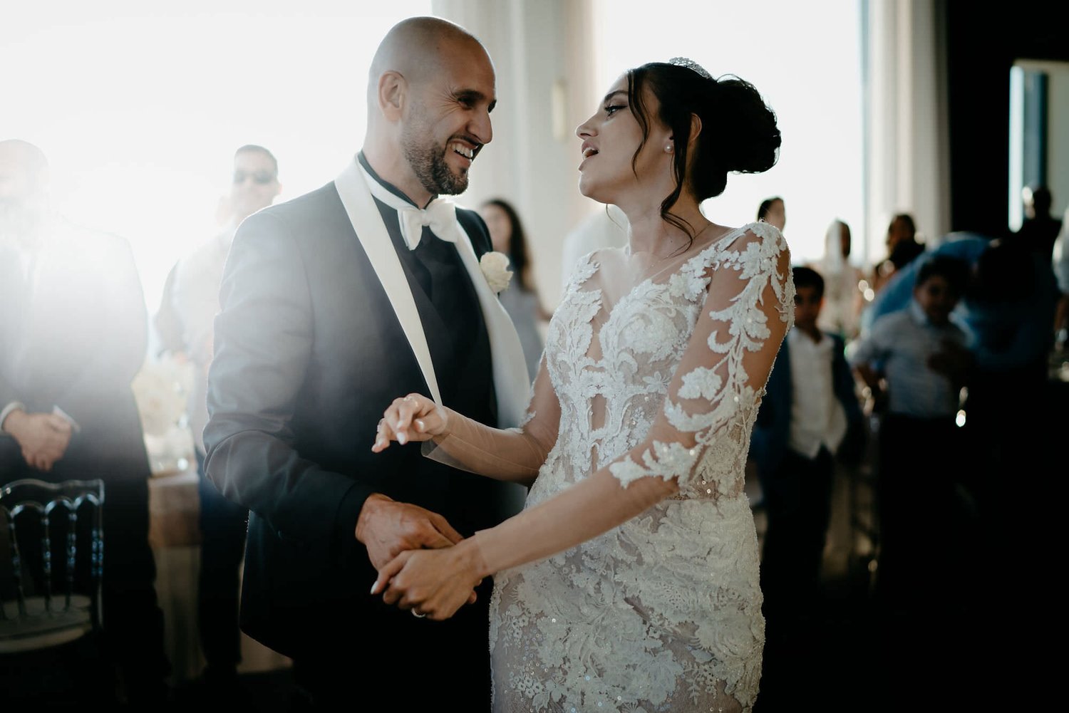 Kareline_Amir_347 - Bride and groom holding hands and looking at each other during wedding reception.jpg