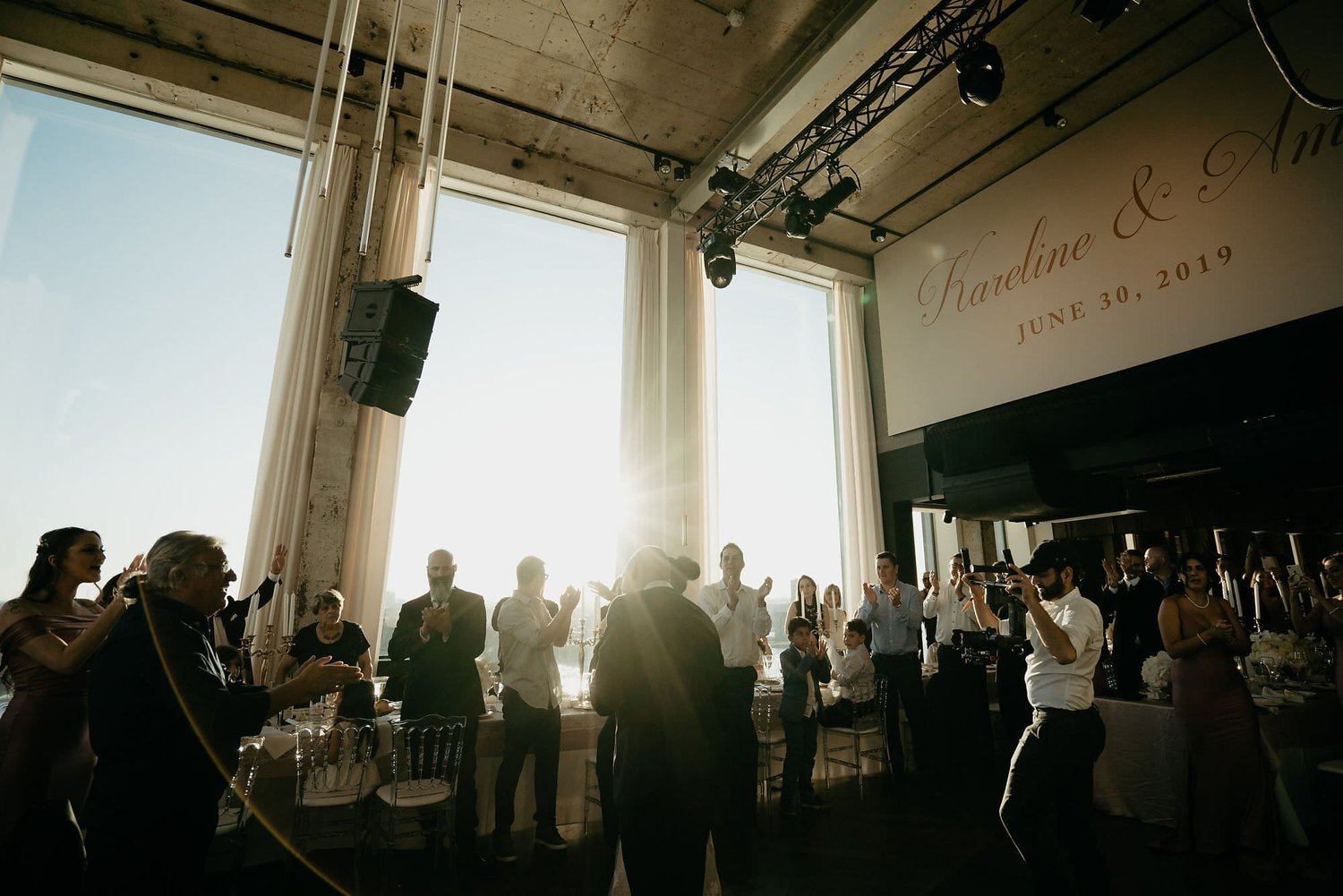 Kareline_Amir_350 - Guests applauding bride and groom at wedding reception in a'dam tower, amsterdam.jpg