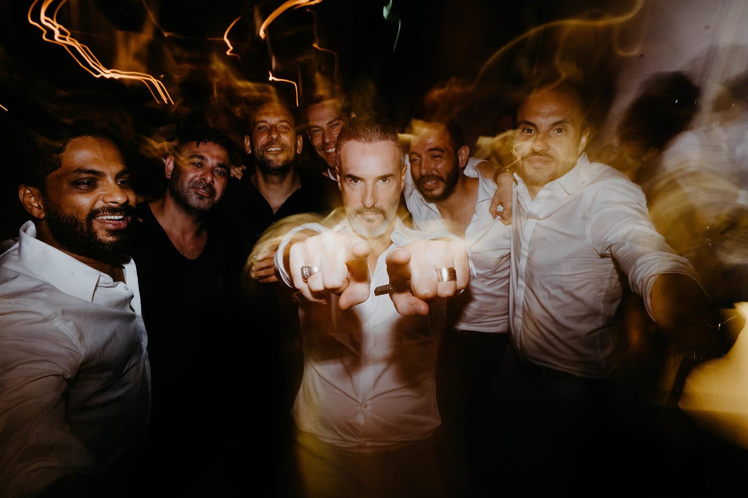 Kareline_Amir_453 - Groomsmen pointing fingers at wedding party in amsterdam loft.jpg